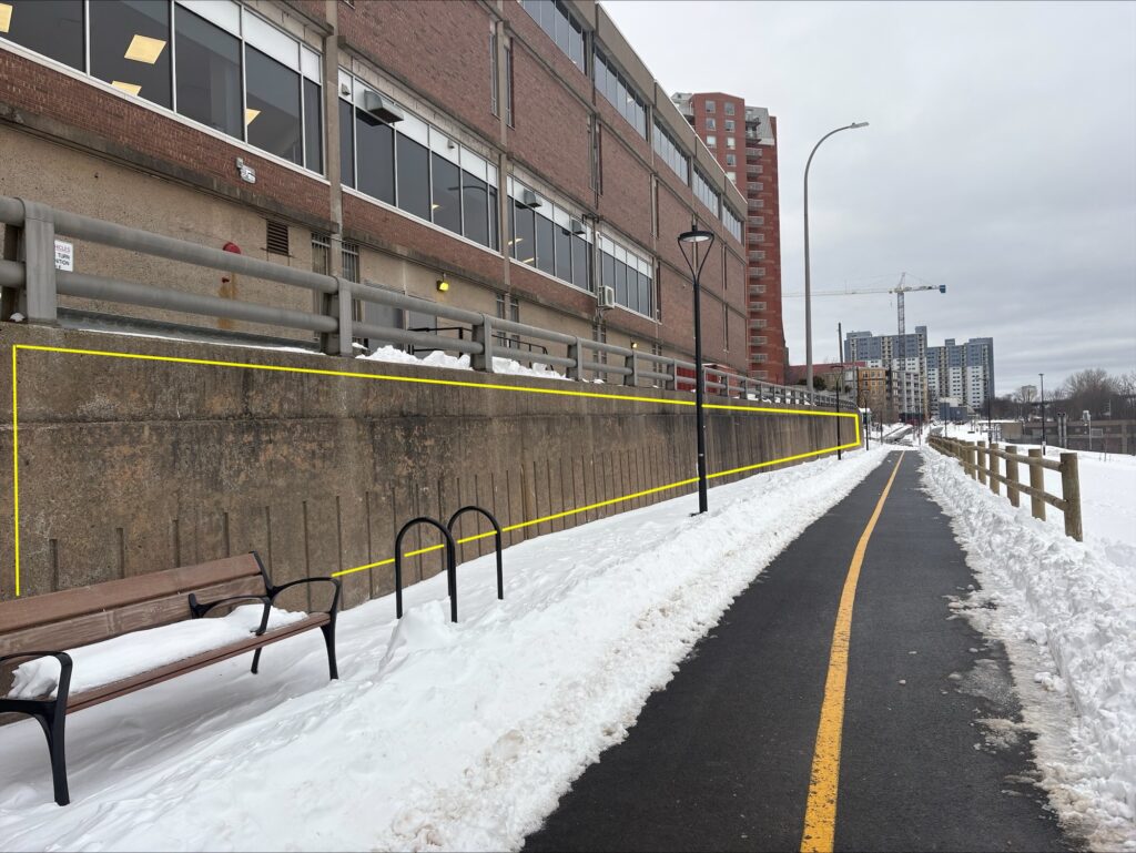 concrete retaining wall with a yellow rectangle depicting the mural opportunity.
